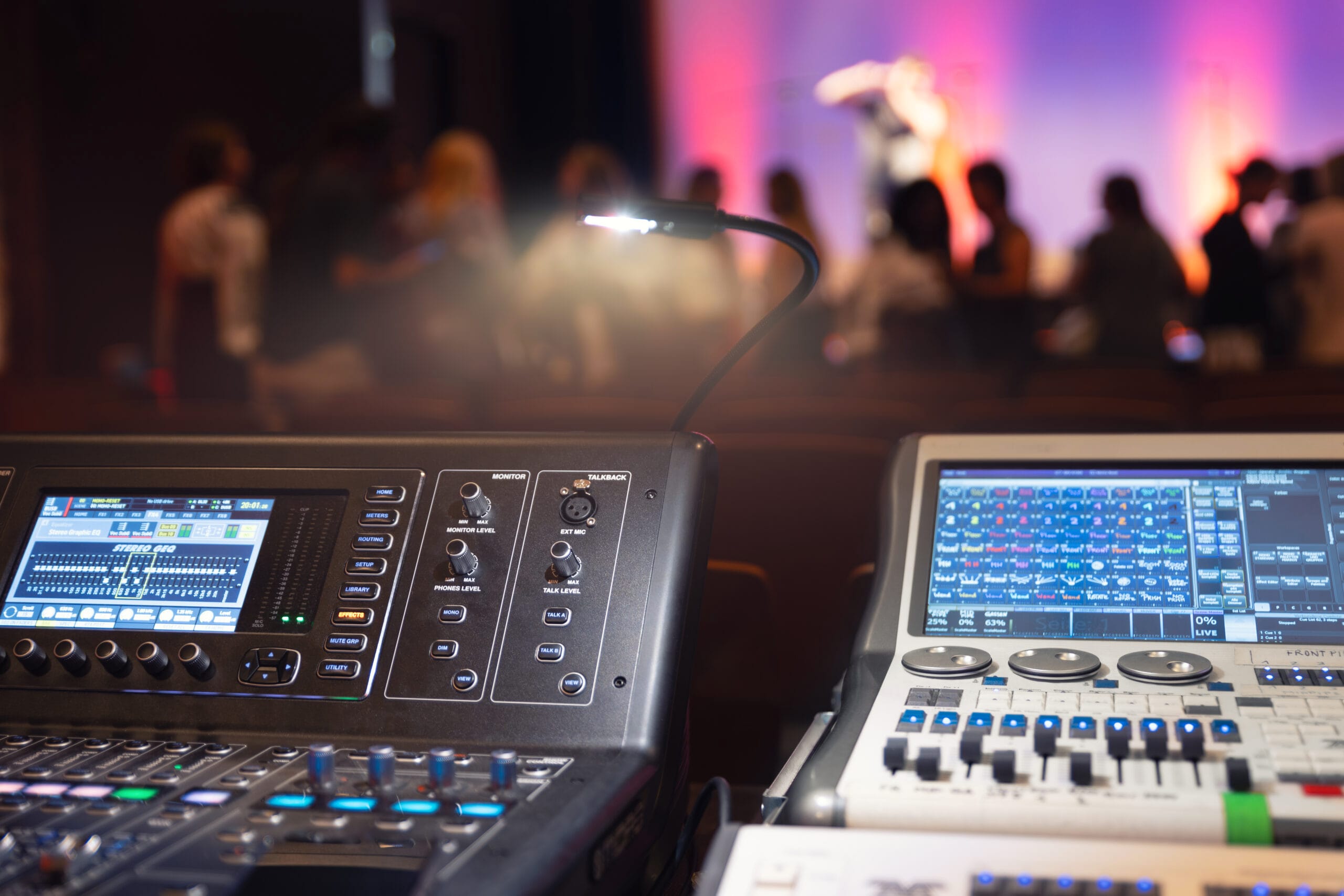 Live theater concert show sound video music control console with scene lights background. Sound engineer mixer soundboard equipment with many knobs, buttons, faders, equalizer screen and light Live theater concert show sound video music control console with scene lights background. Sound engineer mixer soundboard equipment with many knobs, buttons, faders, equalizer screen and light